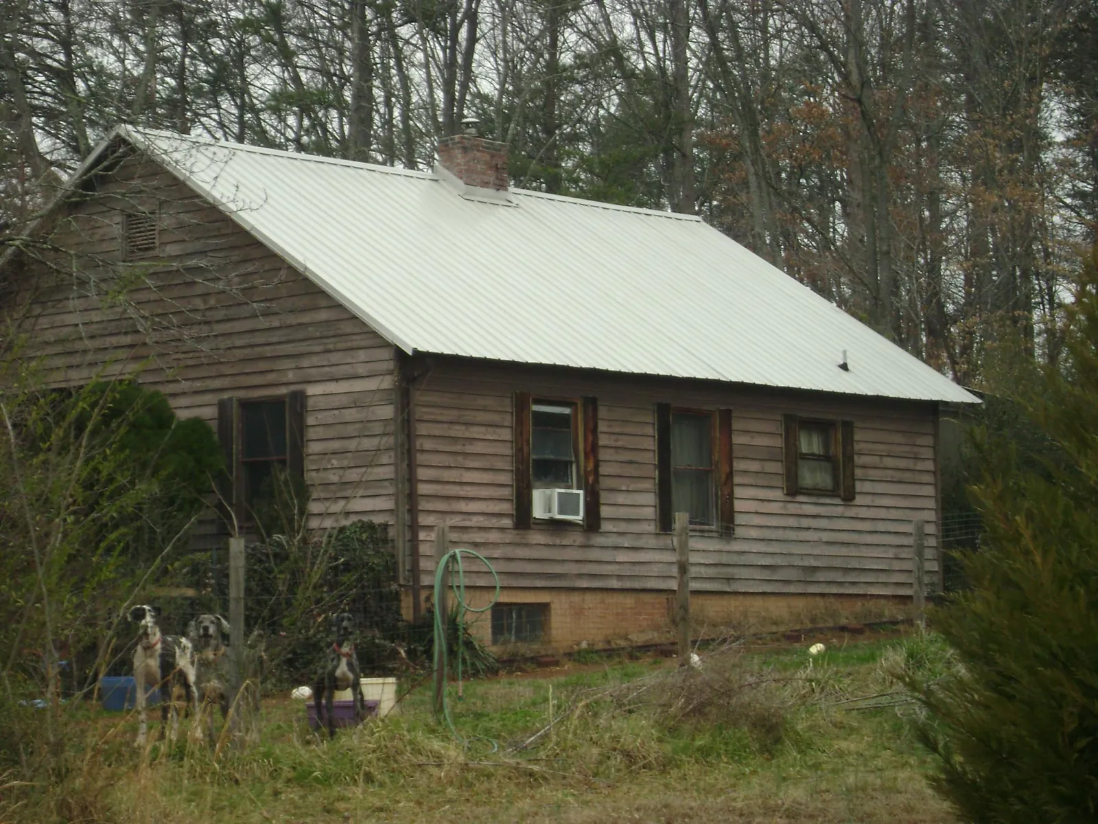 White metal roof on an old wood sided farmhouse, from a Metal Roof Installation job in Bethany